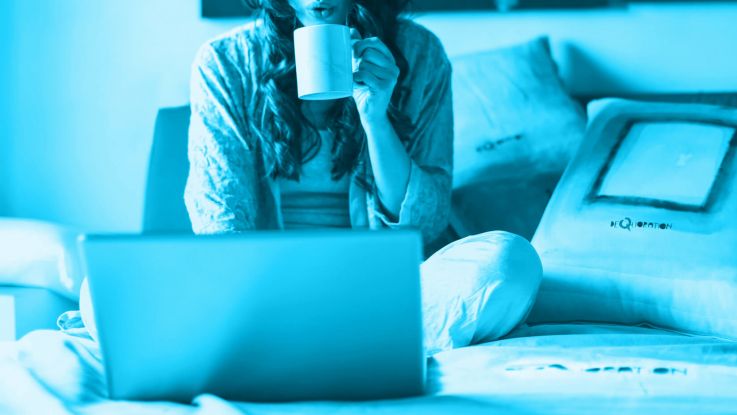 working from home on a bed