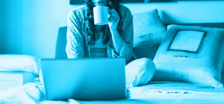 working from home on a bed